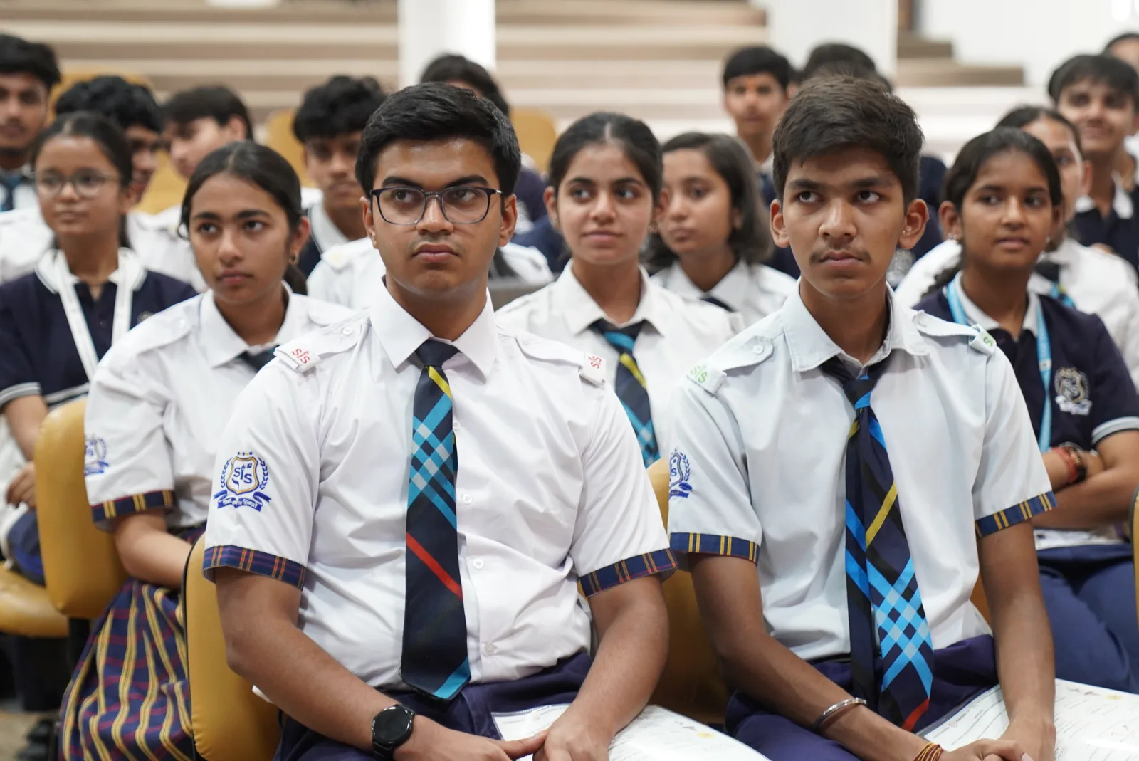Students seated together during a school auditorium session