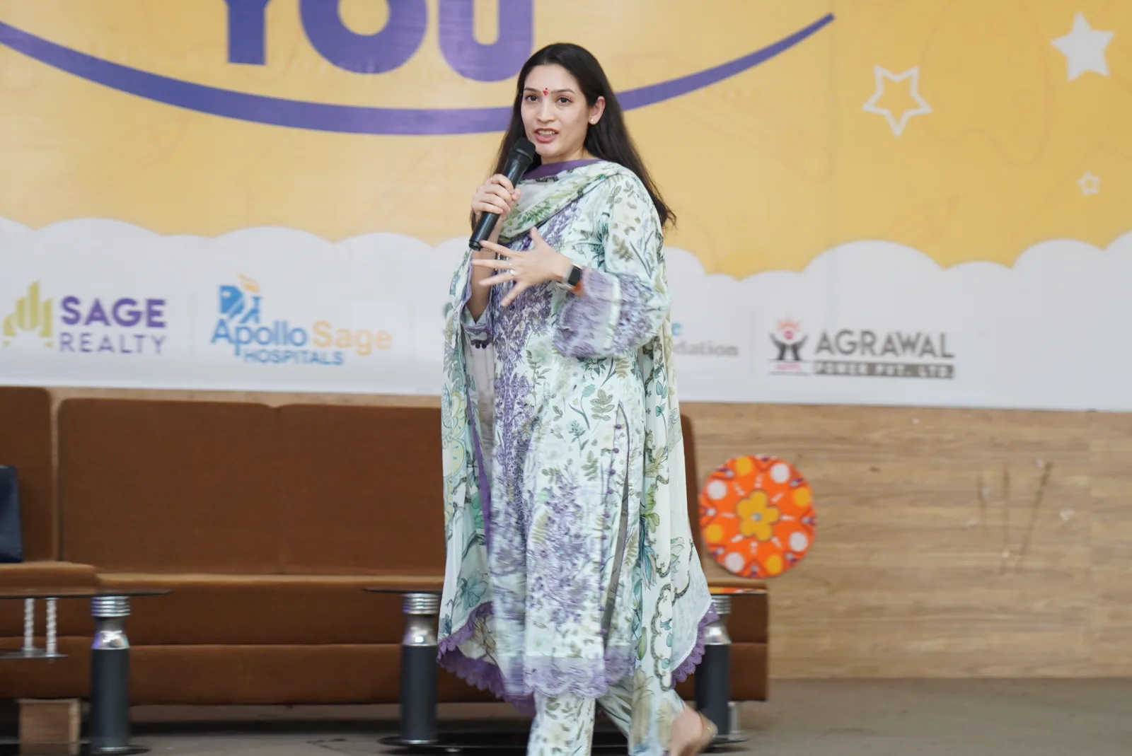 A speaker addressing students from an auditorium stage