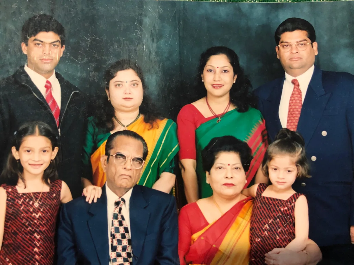 An extended family in formal dress posed for a studio portrait