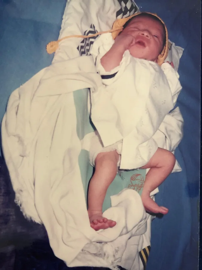 A newborn wrapped in a white blanket
