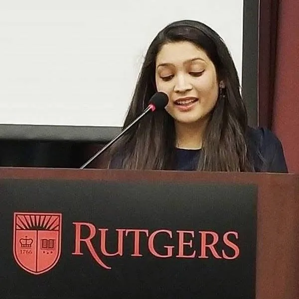 Riddhi Jain speaking at a Rutgers lectern