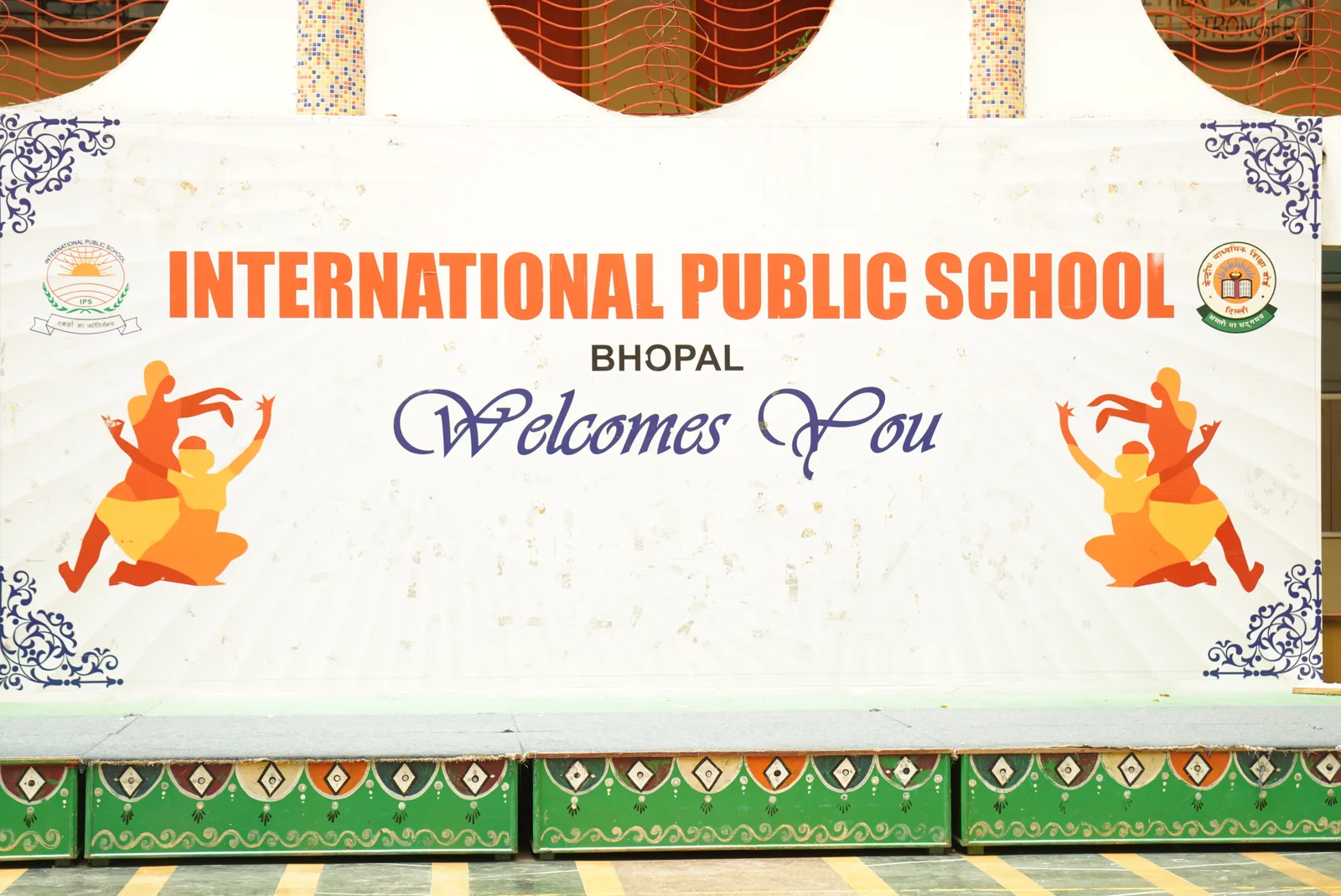 A printed banner reading “International Public School Bhopal welcomes you”